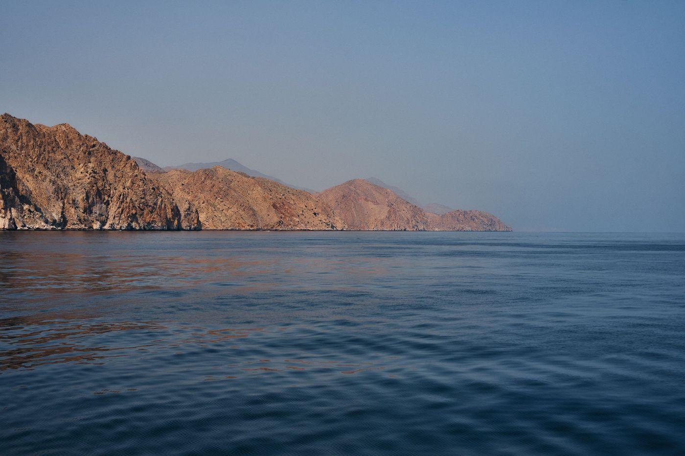Arid coastline meeting shallow turquoise water