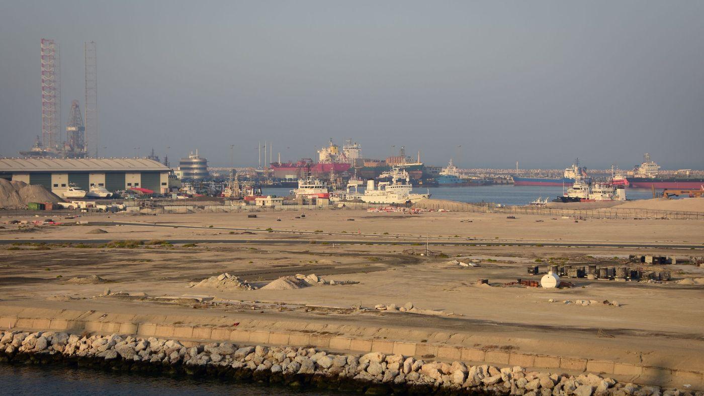 Cranes and berthed vessels at a commercial container terminal