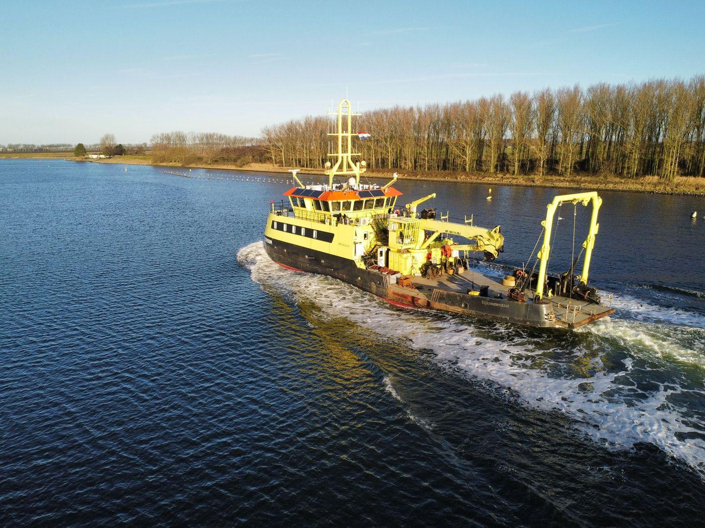 A small survey workboat under way on open water